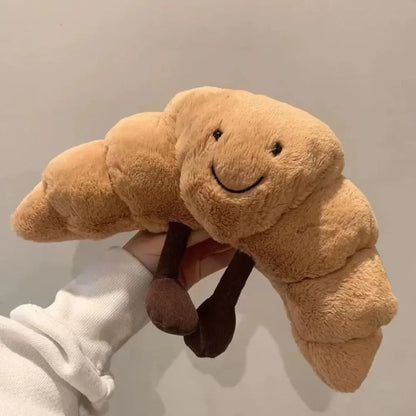 SnuggleCrumb™ – Smiling Croissant Plush Toy – Soft Cuddly Pillow